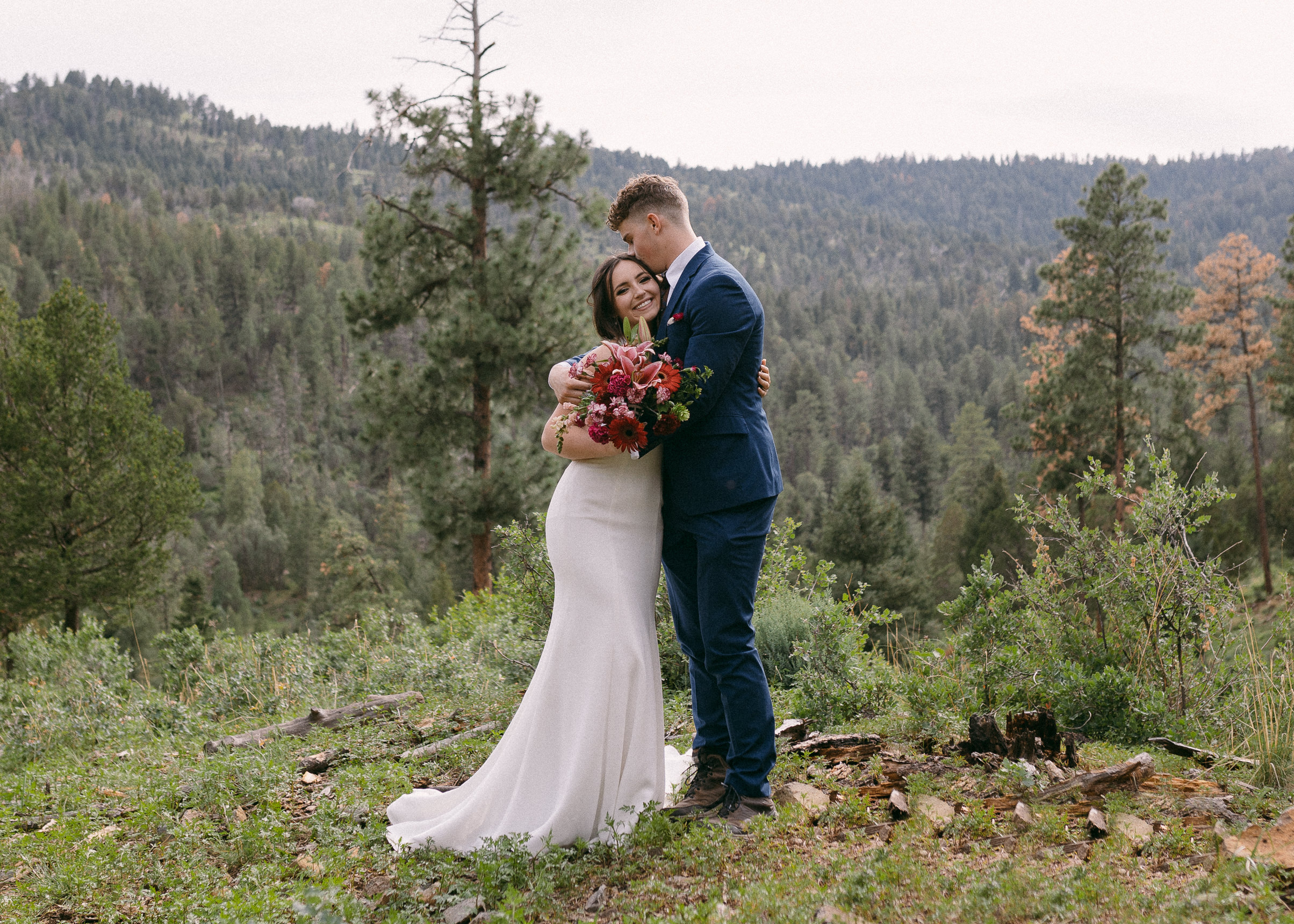 Bride and groom standing and hugging each other during their elopement in Ruidoso, New Mexico.